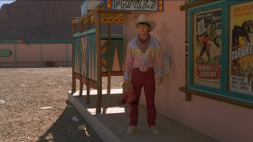 - Are you sure this... stuff is authentic?
- Of course. Haven't you ever seen a Western?
- Yeah, I have, Doc. Clint Eastwood never wore anything like this.
- Clint who?
- That's right. You haven't... heard of him yet.
- Marty, you have to wear the boots. You can't wear those futuristic things... back in 1885. You shouldn't even be wearing them... here in 1955.